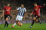 WEST BROMWICH, ENGLAND - DECEMBER 17: Jose Salomon Rondon of West Bromwich Albion (C) attempts to take the ball past Michael Carrick of Manchester United (L) and Marcos Rojo of Manchester United (R) during the Premier League match between West Bromwich Albion and Manchester United at The Hawthorns on December 17, 2016 in West Bromwich, England.  (Photo by Stu Forster/Getty Images)